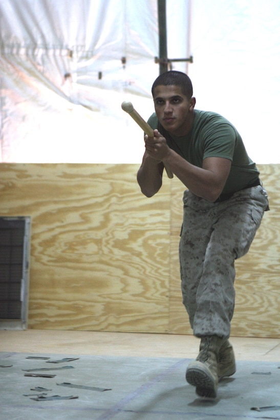 Cpl. Trevor Ryan, a small-arms repairer/technician with Task Force 2nd Battalion, 2nd Marine Regiment, Regimental Combat Team 5, combat glides toward an opponent to execute a disrupt-and-thrust technique at Combat Outpost Rawah, Iraq Sept., 30. Ryan is demonstrating the move for several of his Marine Corps Martial Arts Program students.  Ryan, from Sandusky, Ohio, has a strong passion for teaching MCMAP and for being a Marine.