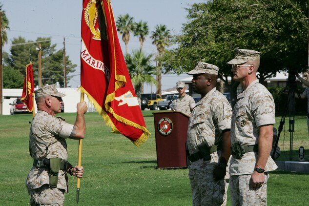 7th Marines Regimental Sgt. Maj. Michael Kufchak, stands with the regimental colors before Lt. Col Michael P. Hubbard relinquishes command of the regiment to Col. Randall P. Newman, during a change-of-command ceremony at the Combat Center’s Torrey L. Gray Field Sept. 30. Hubbard, a native of Lynchburg, Va., assumed command in June, and will continue to serve the regiment as their executive officer. Newman, a native of Economy, Ind., comes to the regiment from the Office of the Secretary of Defense where he served as a military assistant for the executive secretary of the Department of Defense.