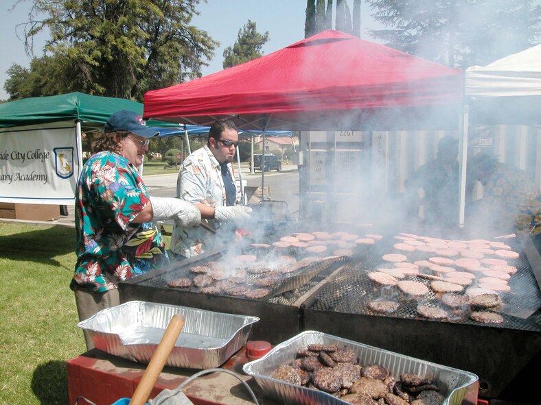 Veterans of Foreign Wars volunteers prepare hamburgers for picnic attendees on a giant grill. The local communities of Riverside and Moreno Valley organized and funded the picnic to show their appreciation to the military members who work at the base. More than 5,000 military members and their families attended the event. This is the 36th appreciate day picnic the community has hosted for March Air Reserve Base.(U.S. Air Force photo by Staff Sgt. Joe Davidson)