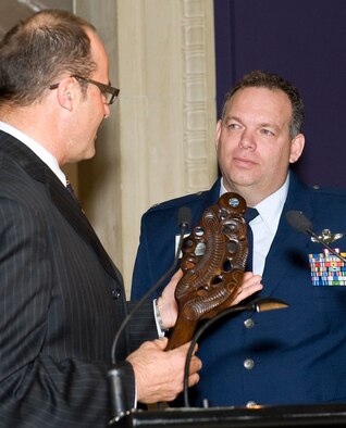 Lou Sanson, Antarctica New Zealand chief executive, presents Lt. Col. Jim McGann with a traditional Maori chief's weapon known as a Patu at a ceremony in Christchurch, New Zealand, Sept. 26. Colonel McGann, who leads C-17 Globemaster III operations in support of Operation Deep Freeze, was presented with the Christchurch Civic Award at the ceremony, becoming the first American to receive the honor. (Photo by Neil MacBeth)
