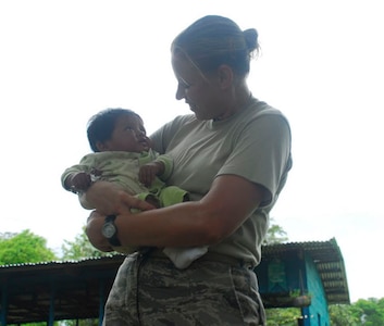 ALTO DE CARONA, Costa Rica - Air Force Tech. Sgt. Jennifer Wampler, Joint Task Force-Bravo Medical Element, holds a child during a break during the three-day medical readiness exercise. It wasn't hard for U.S. servicemembers to interact with the community, as many of the servicemembers were truly humbled by the kindness the people in the villages extended to them. Spending time with children and speaking about life in Costa Rica and the United States, became an important and memorable part of the mission for many of the servicemembers and volunteers. (U.S. Air Force photo by Staff Sgt. Joel Mease)