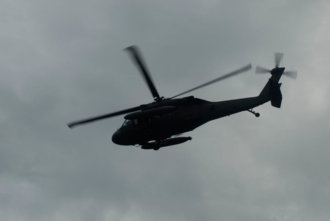 ALTO DE CARONA, Costa Rica - A Blackhawk helicopter flies over stormy skies here Sept. 27, to support medical operations in Alto De Carona and La Pena, Costa Rica. While weather hampered some flight operations during the three-day operation, Joint Task Force-Bravo servicemembers were successful in providing airlift support to a region that takes 12-14 hours by horse to reach. The airlift allowed medical professionals from JTF-Bravo and Costa Rica to deliver needed medical supplies and personnel to the sites. (U.S. Air Force photo by Staff Sgt. Joel Mease)