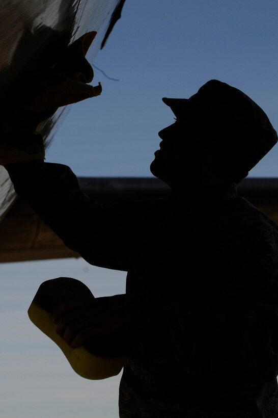 Staff Sgt. Shaun Jansen, 28th Bomb Wing chaplain assistant, cleans a C-54 "Skymaster" aircraft as part of the Adopt-a-Plane program at the South Dakota Air and Space Museum, Sept. 29. The program involves Airmen working together to enhance aircraft displays by cleaning, painting and taking overall better care of them. (U.S. Air Force photo/Airman Matthew Flynn)
 