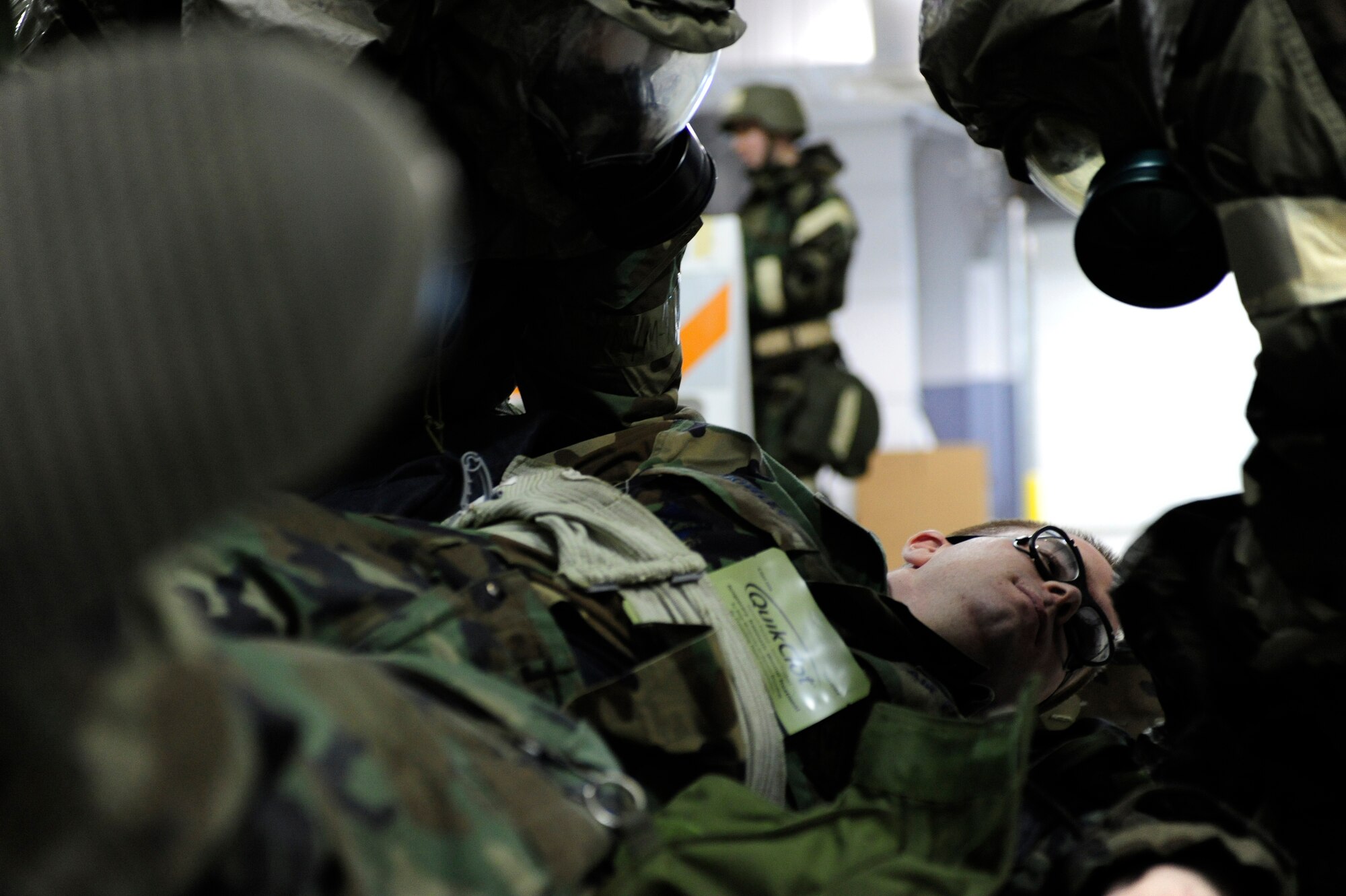 Senior Airman Brandon Hillman, right, and Airman 1st Class Scott Hall, left, performs self-aid buddy care on Airman 1st Class Matthew Howley while they are being scored on speed and accuracy during wing readiness day competition Sept. 26, 2008, at Eielson Air Force Base, Alaska. The competition consisted of several four-man teams which represented each squadron on base. The station’s setup involved basic elements of deployment training. All the Airmen are assigned to the 354th Communications Squadron.  (U.S. Air Force photo/Airman 1st Class Jonathan Snyder)