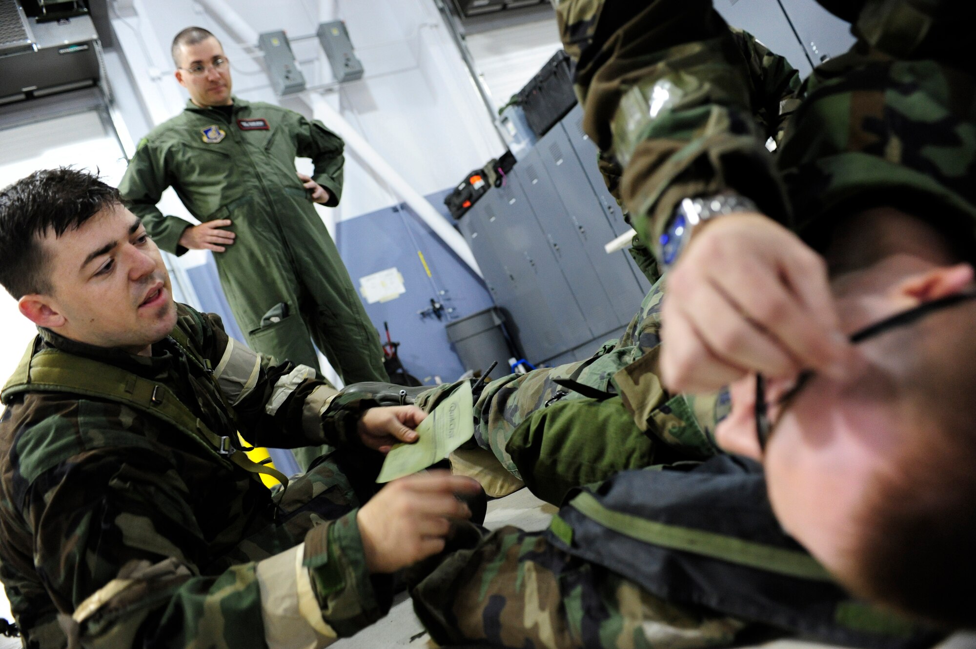 Senior Airman Brandon Hillman, 354th Communications Squadron, performs self-aid buddy care on Airman 1st Class Matthew Howley, 354th Communications Squadron, while they are being scored on speed and accuracy during a wing readiness day competition Sept. 26, 2008, at Eielson Air Force Base, Alaska. The competition consisted of several four-man teams which represented each squadron on base. The station’s setup involved basic elements of deployment training.  (U.S. Air Force photo/Airman 1st Class Jonathan Snyder)