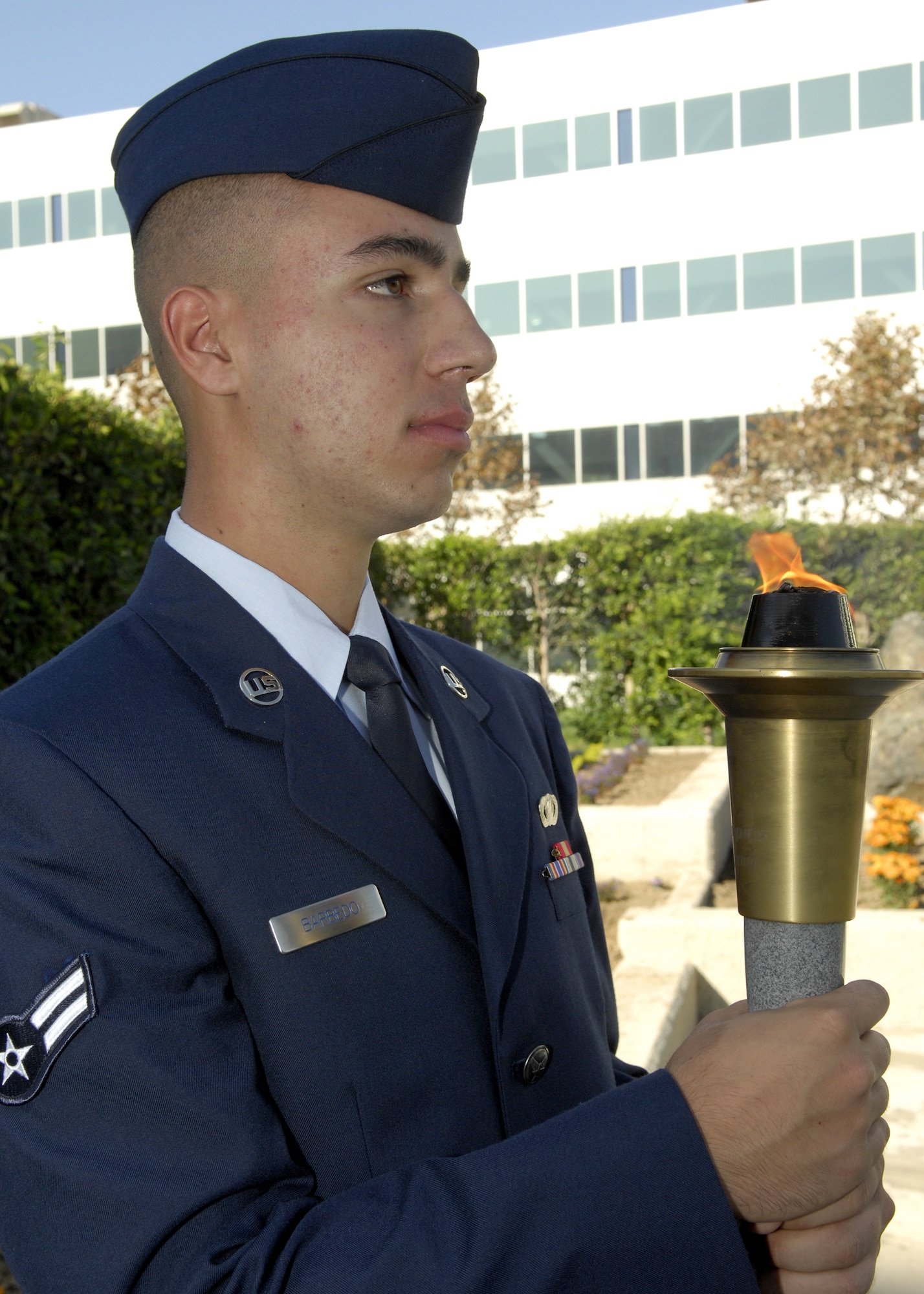 Airman 1st Class Turkha Barbedo, 61st Air Base Wing Financial Management, represented all the men and women of Space and Missile Systems Center as he holds the torch during the POW/MIA Wreath Laying Ceremony at the Schiever Space Complex courtyard, Sep. 19. The ceremony was preceded by a 24-hour torch relay commemorating the National POW/MIA Recognition Day, which more than 180 military, civilian, contractor, and family members from Los Angeles Air Force Base participated. (Photo by Stephen Schester)