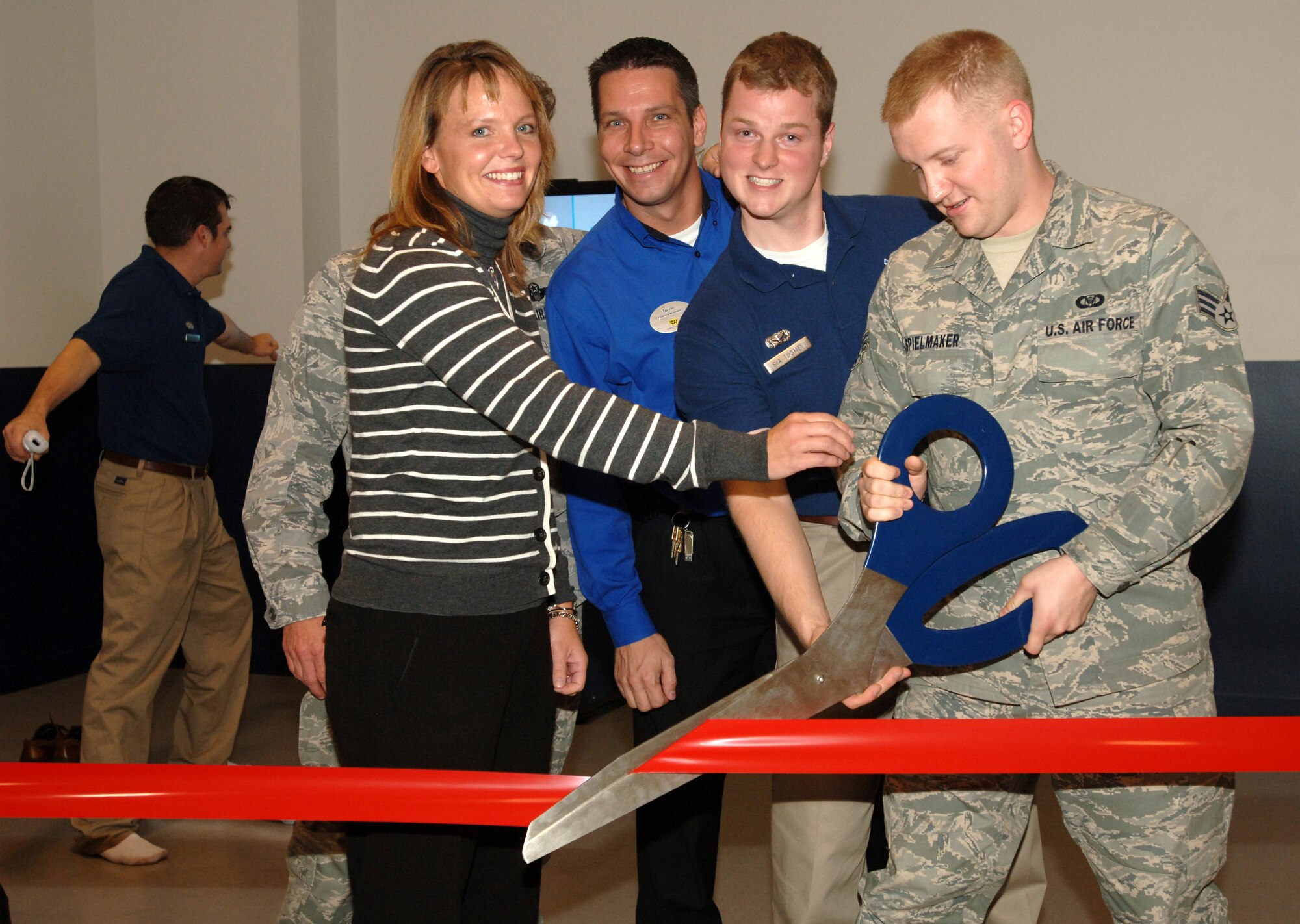 (Left to Right)Ms. Denae Grove, 319th Health and Wellness Center; Mr. Torrie Enget, Manager, Best Buy; SrA Brandon Toomey, 319th Force Support Squadron; and SrA Eric Spielmaker, 319 FSS cut the ribbon on the new Wii Fit(R) area at Grand Forks Air Force Base.  The new fitness center addition is the first of its kind in the Air Force and is based on the popular game system, the Nintendo(TM) Wii(R).  The Wii Fit(R) program has been shown to improve fitness in a fun, exciting new way. No federal endorsement of Best Buy(TM) or Nintendo(TM) is given or implied. (U.S. Air Force photo/Tech. Sgt. Joseph Kapinos)
