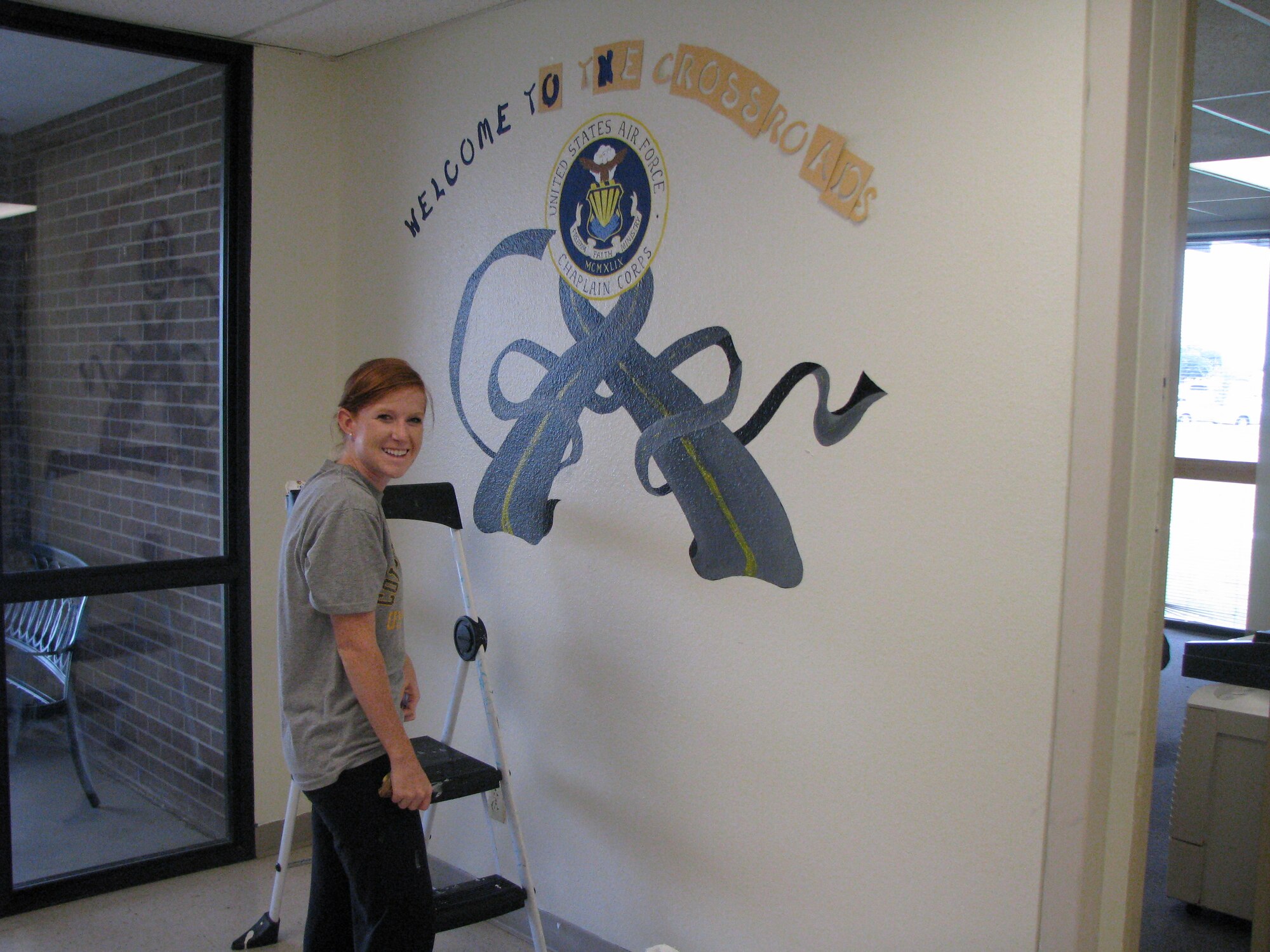 2nd Lt. Amy Meyer, a 17th Training Group student, paints a mural at the Crossroads Student Center on Goodfellow Air Force Base, Texas. (U.S. Air Force photo)