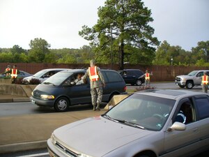 LANGLEY AIR FORCE BASE, Va. -- Cars are lined up at the west gate as Langley chief master sergeants check identification cards Sept. 26. The chiefs checked ID’s and greeted over five thousand Airmen, civilians and visitors as they drove onto base. “As chiefs, we believe this is an important antiterrorism and force protection effort our Airman conduct daily, we wanted to show our support,” said Chief Master Sgt. James Johnston, 1st Security Forces manager. (Courtesy Photo) 