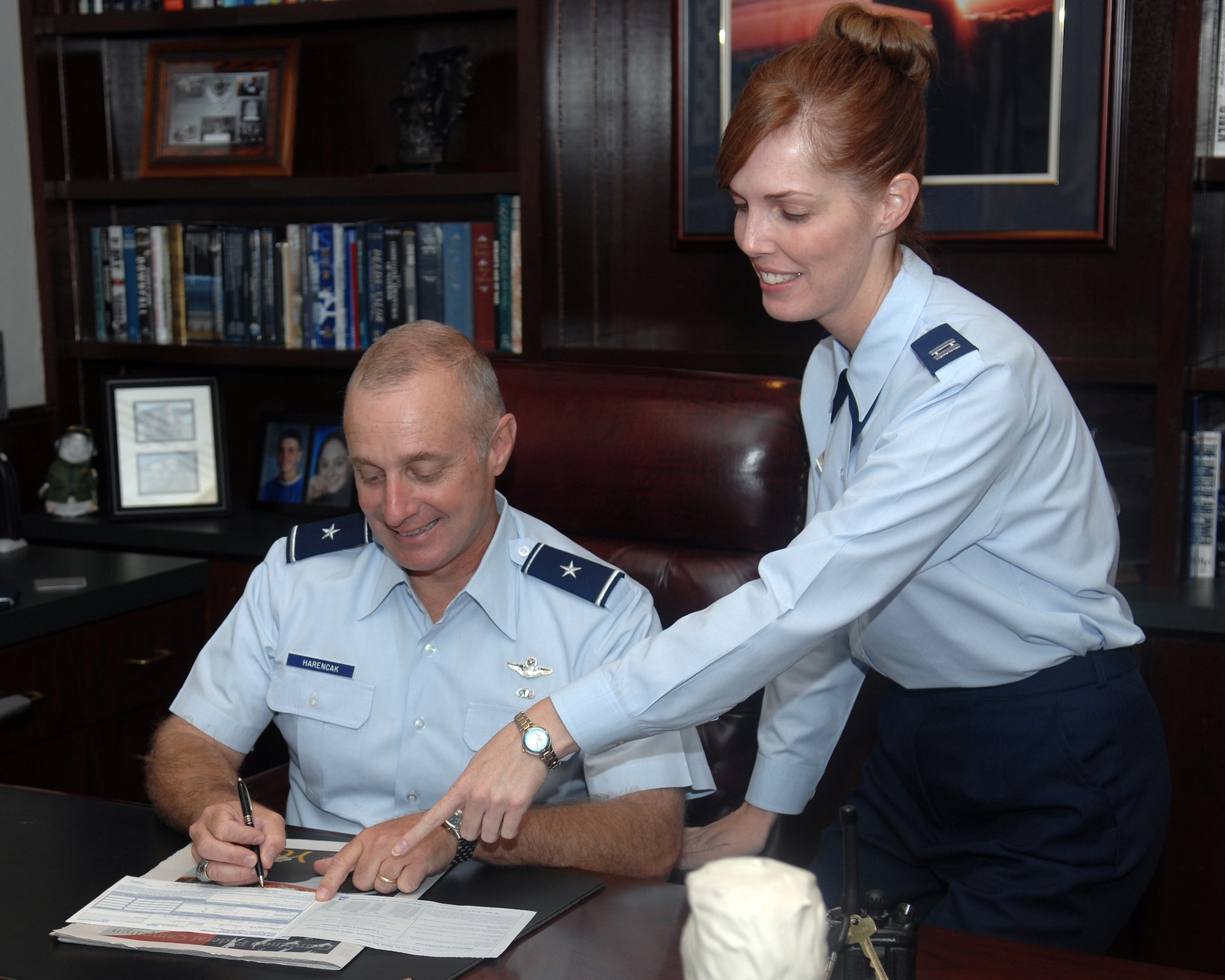 WHITEMAN AIR FORCE BASE, Mo. -Brig. Gen. Garrett Harencak, 509th Bomb Wing commander, reviews the Combined Federal Campaign contribution form with Capt. Tracy Cooper, 509th Bomb Wing CFC manager, Sept. 29. CFC is the world's largest and most successful annual workplace charity campaign, with more than 300 CFC campaigns throughout the country and internationally to help to raise millions of dollars each year. Pledges can be made by military donors during the campaign season, which runs from Oct. 1 - Nov. 12, to support eligible non-profit organizations that provide health and human service benefits throughout the world. (U.S. Air Force photo/Staff Sgt Charles D. Larkin Sr.)  