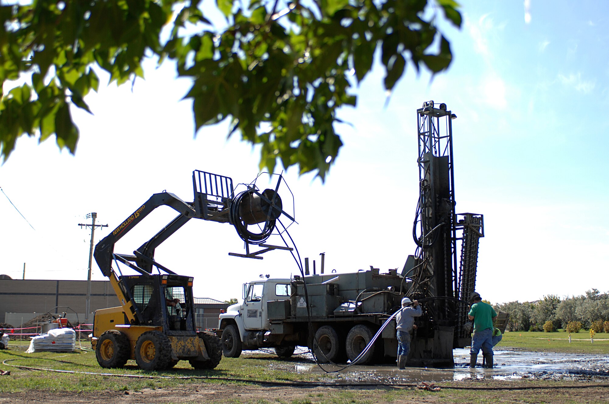 MINOT AIR FORCE BASE, N.D. – Crew members from RNP Installation and Drilling work together installing line for the new geothermal heating system at the 5th Bomb Wing Headquarters building here Sept. 24. This new system, which replaces the old hot water boiler system, will save the Air Force around 30 to 70 percent in heating costs, and 20 to 50 percent in cooling costs. (U.S. Air Force photo by Senior Airman Kelly Timney) 
