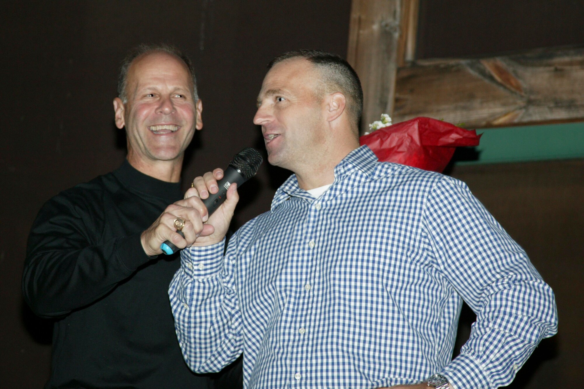 SUMTER, S.C.-- Maj. Gen. Timothy Rush (left), 9th Air Force and U.S. Air Forces Central Air National Guard assistant, takes the microphone from Army Col. Kevin Felix, 4th Battlefield Coordination Detachment commander, to speak to Soldiers and families of the 4th BCD at a farewell dinner at the Carter Cabin Sept. 25. The 4th BCD is preparing to deploy as a unit next week, to Southwest Asia for one year. (U.S. Air Force photo/Staff Sgt. Holly Brown)