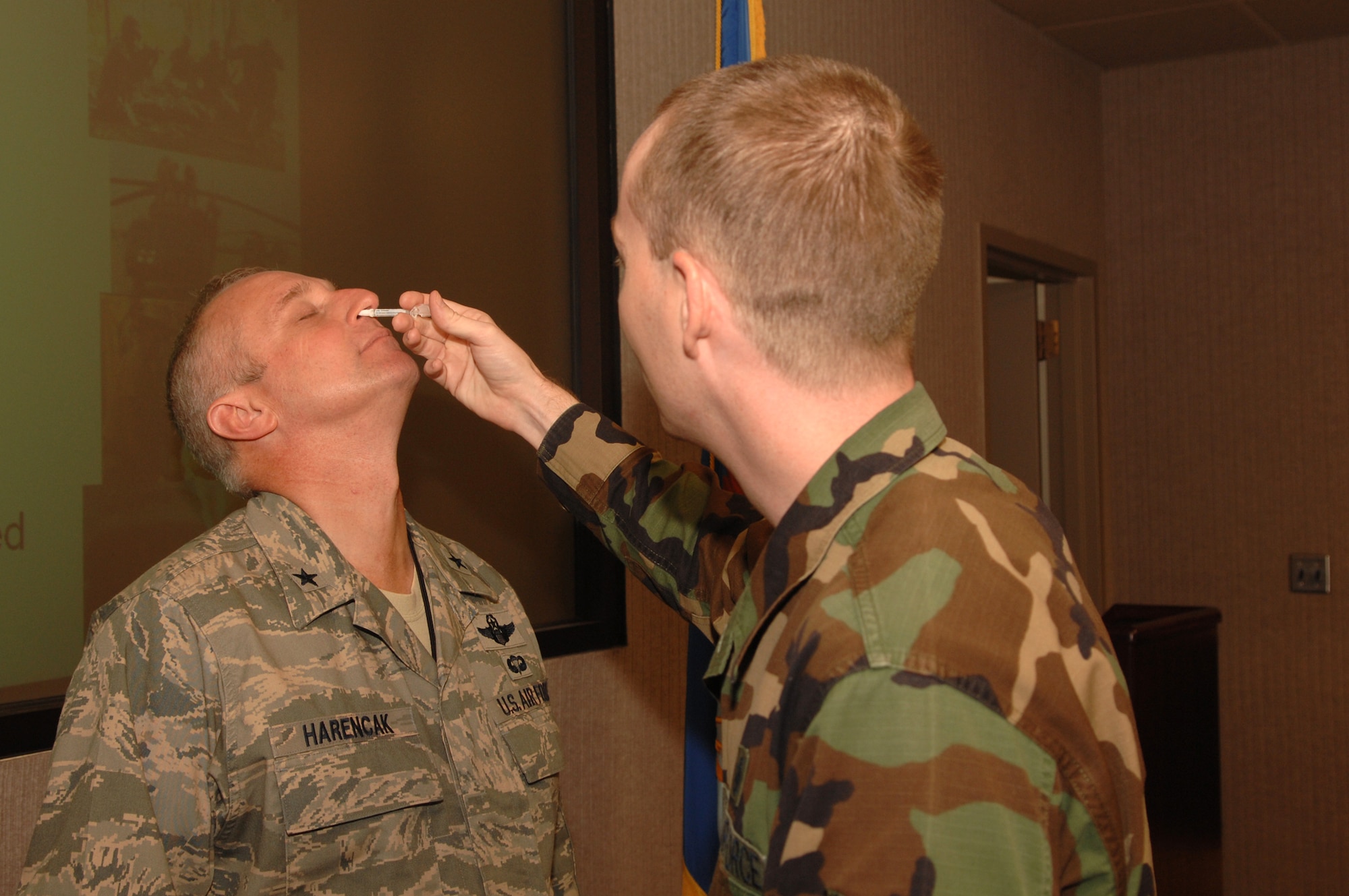 WHITEMAN AIR FORCE BASE, Mo. – Brig. Gen. Garrett Harencak, 509th Bomb Wing commander, receives a FluMist vaccination from Tech. Sgt. Kenneth Norris, 509th Medical Operations Squadron, Sept. 24. Active duty members are required to receive either the FluMist or a flu shot. For more information, call the immunizations clinic at 687-4304.(U.S. Air Force photo/Senior Airman Jessica Snow) 
