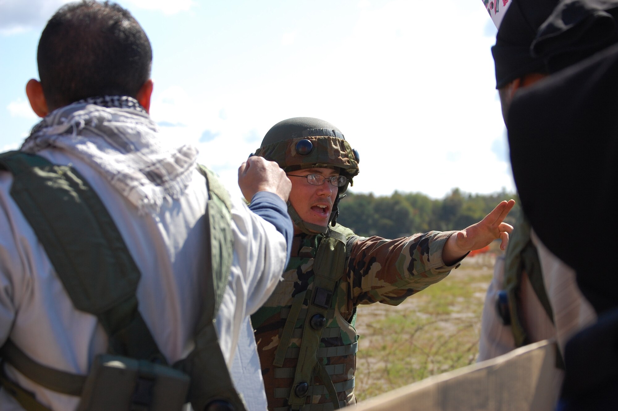 Airmen control protesters in the fictional country of Chimaera during a scenario for Air Force Exercise Eagle Flag 08-6 Sept. 23, 2008, at Naval Air Engineering Station Lakehurst, N.J.  The exercise is managed by the U.S. Air Force Expeditionary Center's 421st Combat Training Squadron and tests and trains Airmen in expeditionary combat support skills.  (U.S. Air Force Photo/Staff Sgt. Desiree N. Palacios)