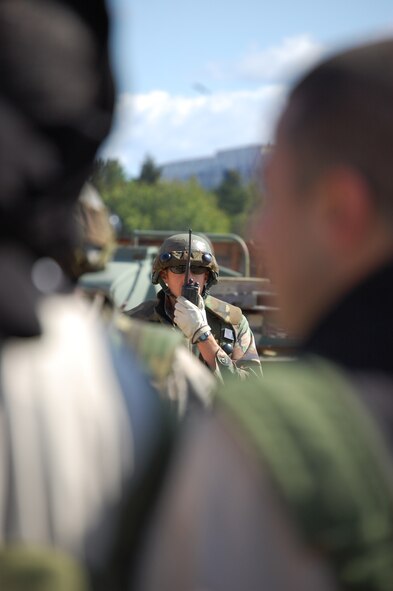 Airmen control protesters in the fictional country of Chimaera during a scenario for Air Force Exercise Eagle Flag 08-6 Sept. 23, 2008, at Naval Air Engineering Station Lakehurst, N.J.  The exercise is managed by the U.S. Air Force Expeditionary Center's 421st Combat Training Squadron and tests and trains Airmen in expeditionary combat support skills.  (U.S. Air Force Photo/Staff Sgt. Desiree N. Palacios)