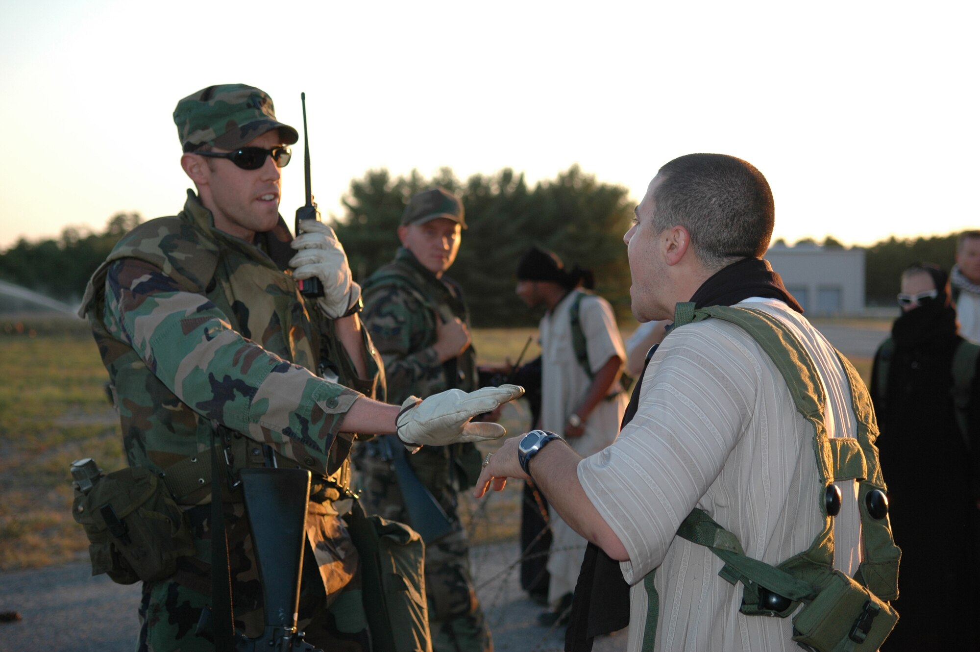 Airmen control protesters in the fictional country of Chimaera during a scenario for Air Force Exercise Eagle Flag 08-6 Sept. 23, 2008, at Naval Air Engineering Station Lakehurst, N.J.  The exercise is managed by the U.S. Air Force Expeditionary Center's 421st Combat Training Squadron and tests and trains Airmen in expeditionary combat support skills.  (U.S. Air Force Photo/Airman 1st Class Rachel Kocin)