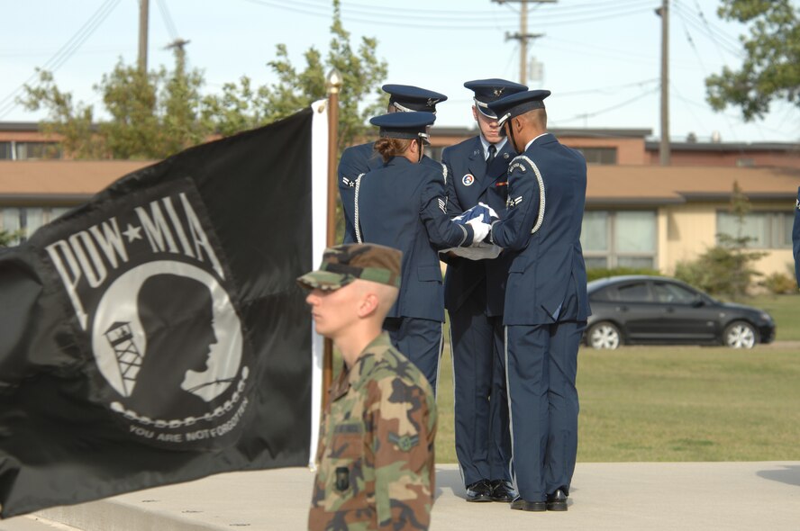 MINOT AIR FORCE BASE, N.D. -- Members of the Minot Air Force Base Honor Guard retire the colors during the POW/MIA Recognition Day retreat ceremony here Sept. 29.  The ceremony was organized as a joint effort between the 5th Bomb Wing and 91st Missile Wing as a way to pay tribute to all prisoners of war and missing in action service-members, who have served, suffered and given their lives for our nation. (U.S. Air Force photo by Staff Sgt. Keith Ballard) 