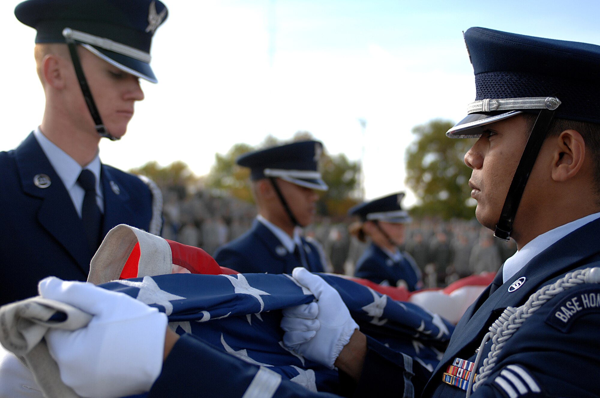 MINOT AIR FORCE BASE, N.D. – Members of the Minot Air Force Base Honor Guard retire the colors during the POW/MIA Recognition Day retreat ceremony here Sept. 29.  The ceremony was organized as a joint effort between the 5th Bomb Wing and 91st Missile Wing as a way to pay tribute to all prisoners of war and missing in action service-members, who have served, suffered and given their lives for our nation. (U.S. Air Force photo by Senior Airman Kelly Timney) 