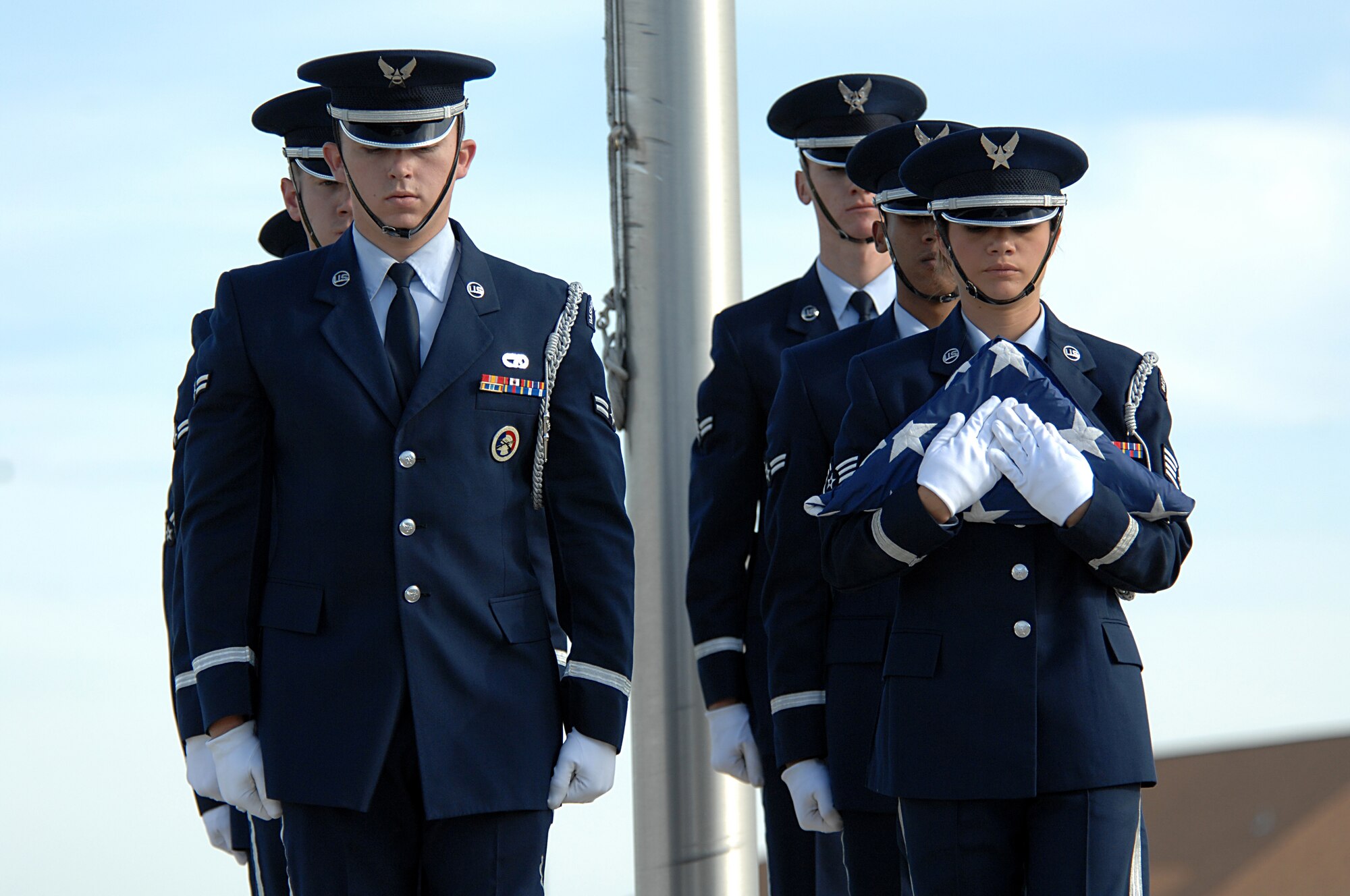 MINOT AIR FORCE BASE, N.D. – Marching in unison after retiring the colors, the members of the base honor guard descend the stairs during the POW/MIA Recognition Day retreat ceremony here Sept. 29. The ceremony was organized as a joint effort between the 5th Bomb Wing and 91st Missile Wing as a way to pay tribute to all prisoners of war and missing in action service-members, who have served, suffered and given their lives for our nation. (U.S. Air Force photo by Senior Airman Kelly Timney) 