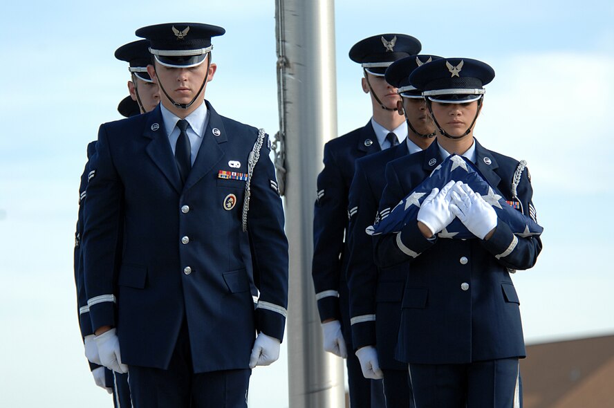MINOT AIR FORCE BASE, N.D. – Marching in unison after retiring the colors, the members of the base honor guard descend the stairs during the POW/MIA Recognition Day retreat ceremony here Sept. 29. The ceremony was organized as a joint effort between the 5th Bomb Wing and 91st Missile Wing as a way to pay tribute to all prisoners of war and missing in action service-members, who have served, suffered and given their lives for our nation. (U.S. Air Force photo by Senior Airman Kelly Timney) 