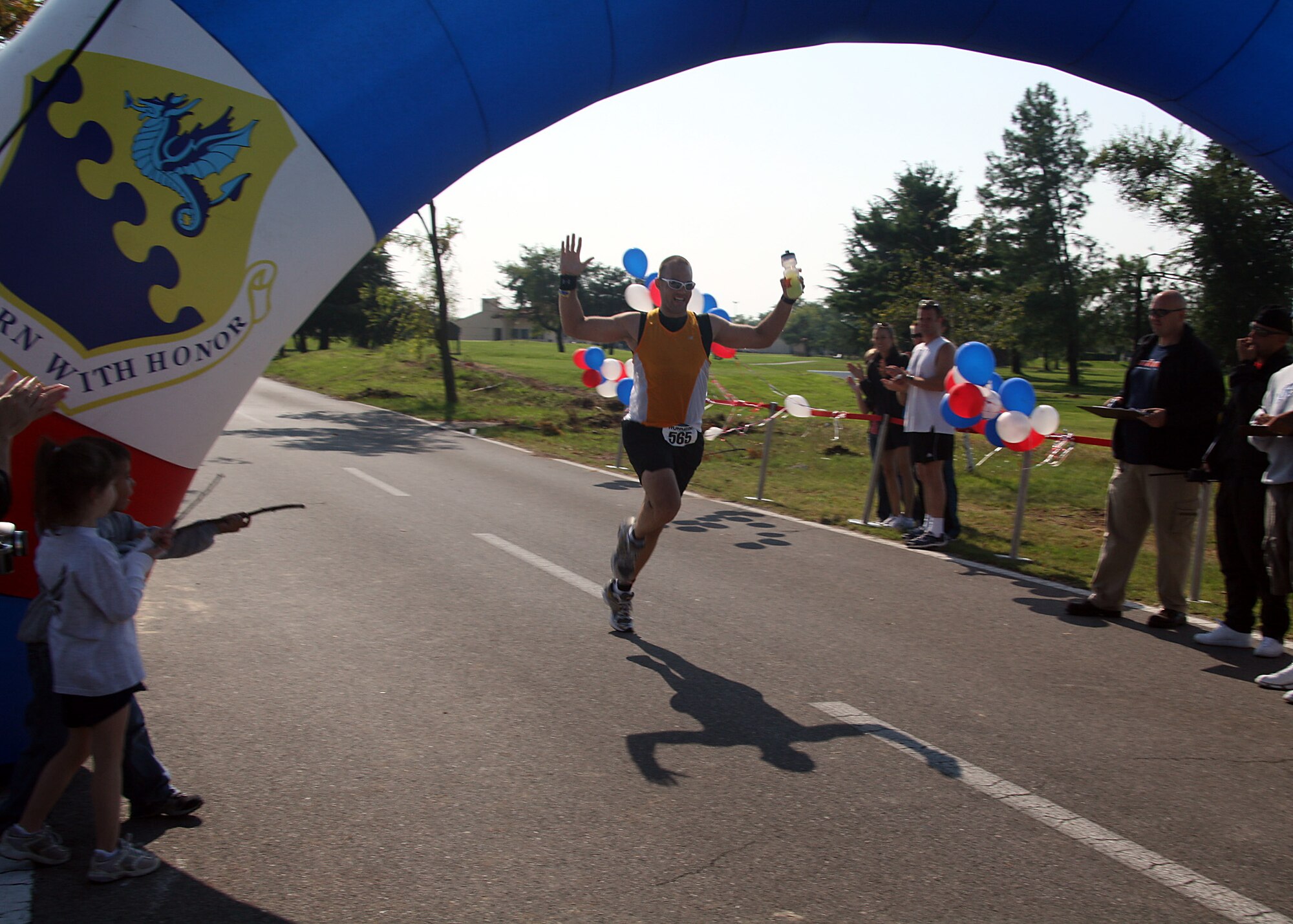Staff Sgt. Brian Morris, 31, of Royal Air Force Mildenhall, England, crosses the finish line of the 2nd Annual Aviano Air Force Base Marathon held in Aviano, Italy, on Sept. 20. Sergeant Morris was the first overall finisher for the marathon division with a time of 3:19:50. (U.S. Air Force courtesy photo)