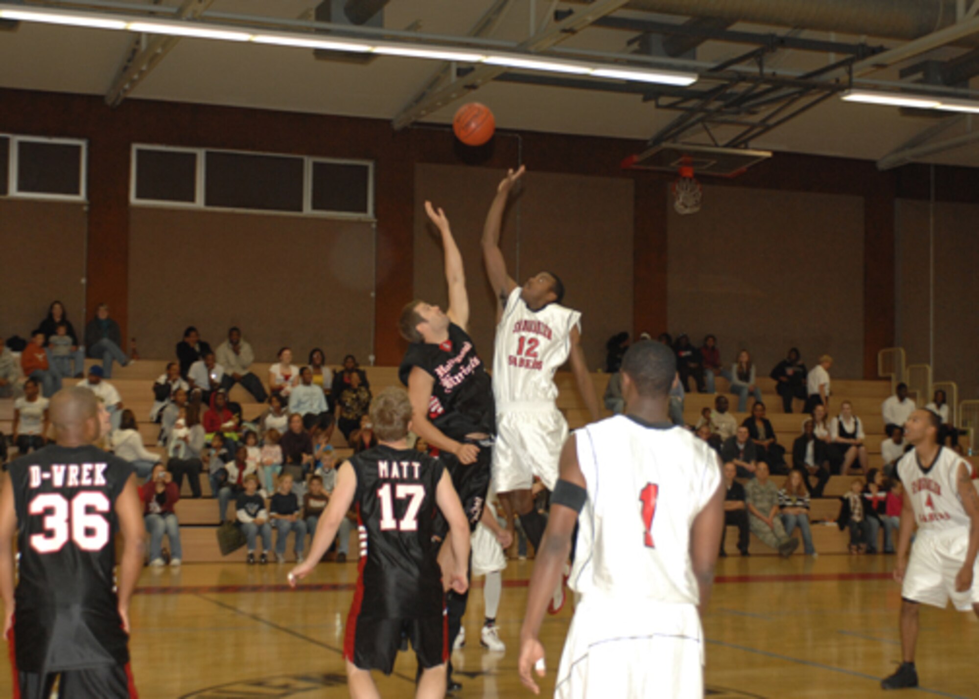 SPANGDAHLEM AIR BASE, Germany— A face-off marks the beginning of the game between Spangdahlem Sabers and Hollywood Knights celebrity basketball team, Sept. 25.  The Hollywood Knights are working with the United Service Organization touring Germany, Netherlands and Belgium Sept. 18-28. (Photo by Staff Sgt. Kristin Ruleau)