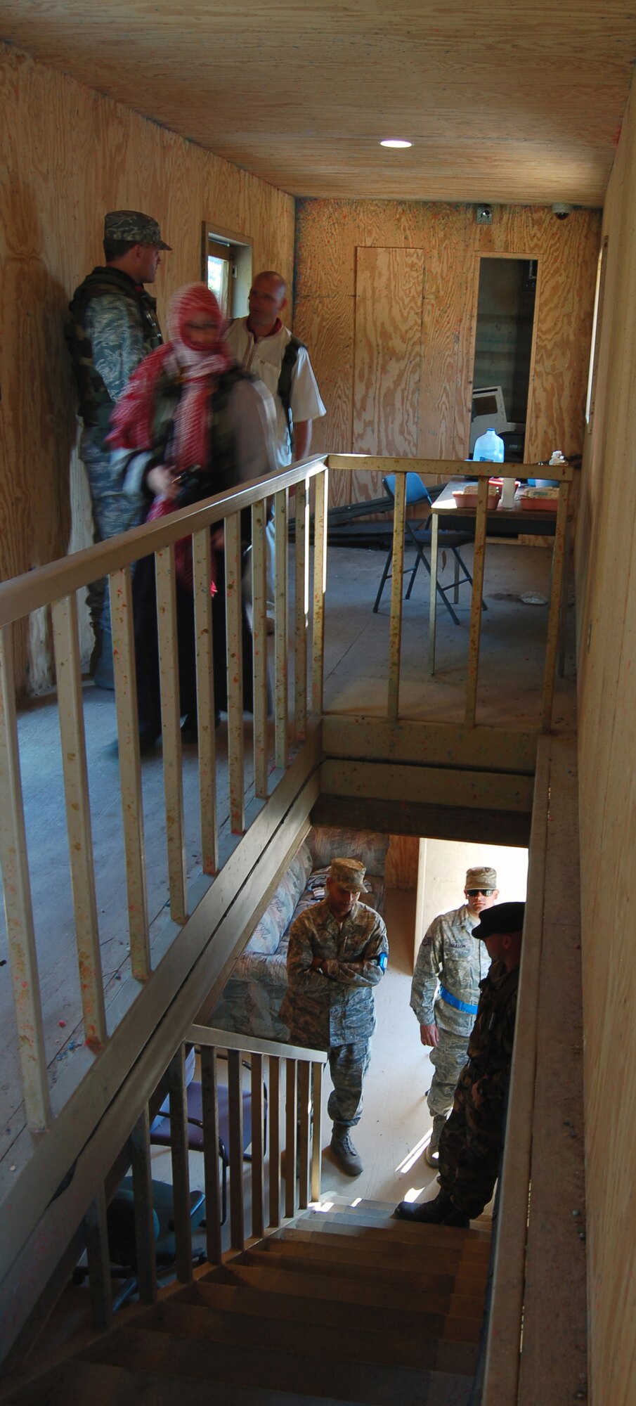 A participant in Air Force Exercise Eagle Flag 08-6 engages in a conversation with role players (above) as exercise cadre (below) listen to them during a scenario for Eagle Flag Sept. 20, 2008, at Naval Air Engineering Station Lakehurst, N.J.  The exercise is managed by the U.S. Air Force Expeditionary Center's 421st Combat Training Squadron and tests and trains Airmen in expeditionary combat support skills.  (U.S. Air Force Photo/Senior Airman Julius Delos Reyes)