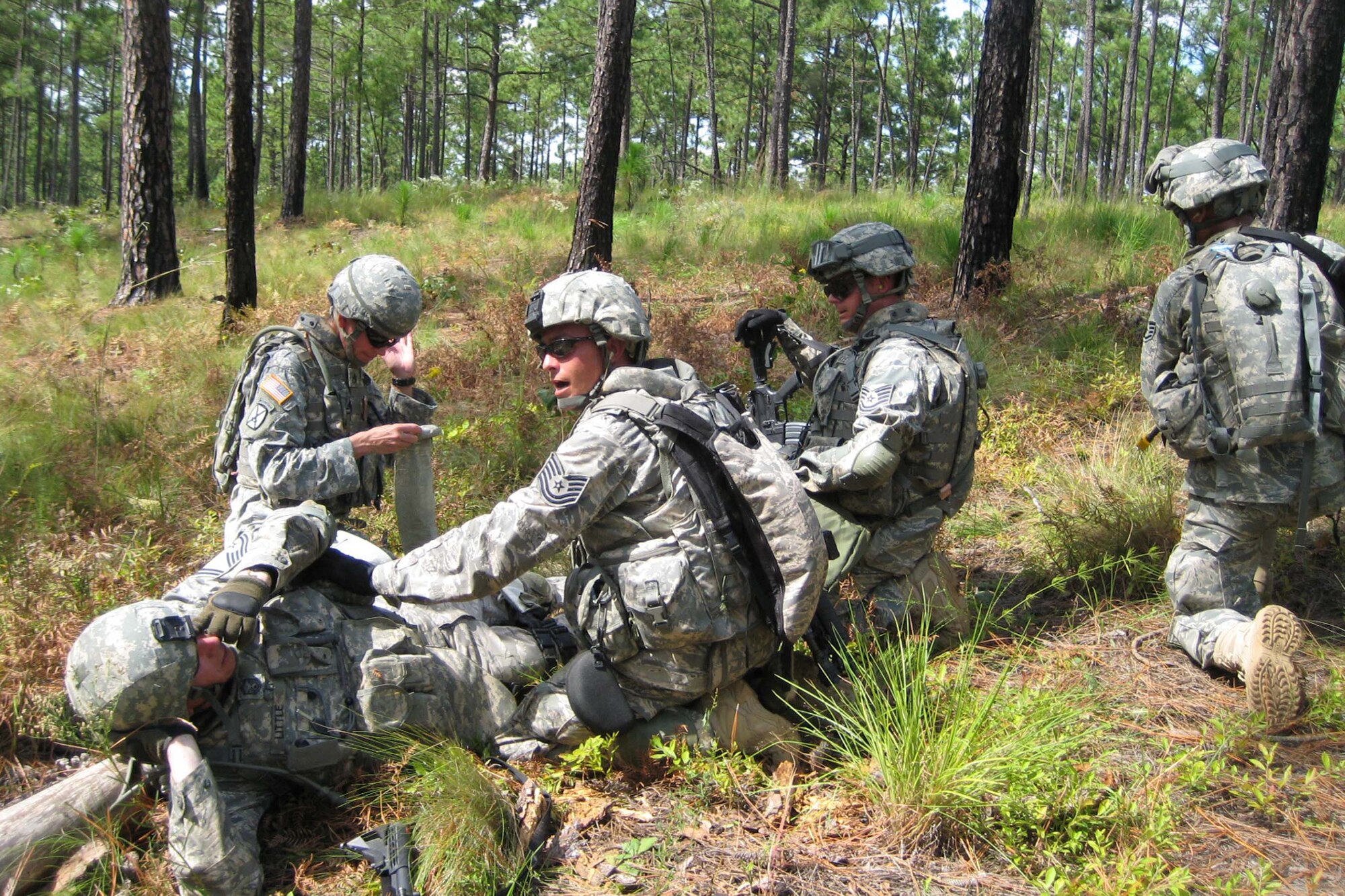 FORT BRAGG, N.C. -- Tech. Sgt. Arthur Sawyer, a member of the Provincial Reconstruction Team deploying to Nangarhar Province, calls for additional assistance during a simulated combat medical scenario during PRT training Sept. 14. Sergeant Sawyer, deployed from Shaw Air Force Base, S.C., is one of more than 175 Airmen training alongside Soldiers and Sailors in preparation to deploy with the joint PRTs.  (Courtesy photo)