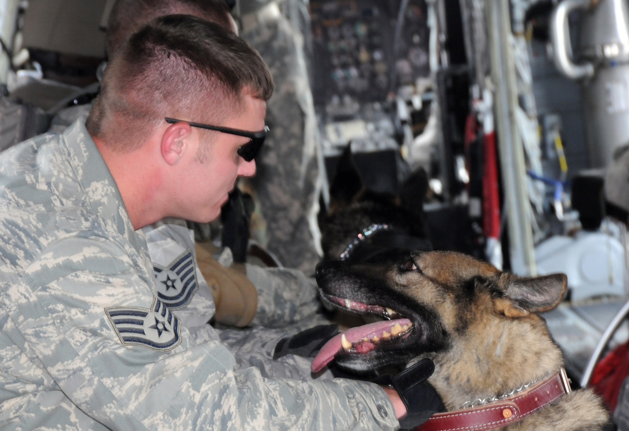 FORT RUCKER, Ala. -- Staff Sgt. James Richey consoles his 5-year-old MWD, Baddy, during a flight Sept. 12. (Photo by Michelle Owens)