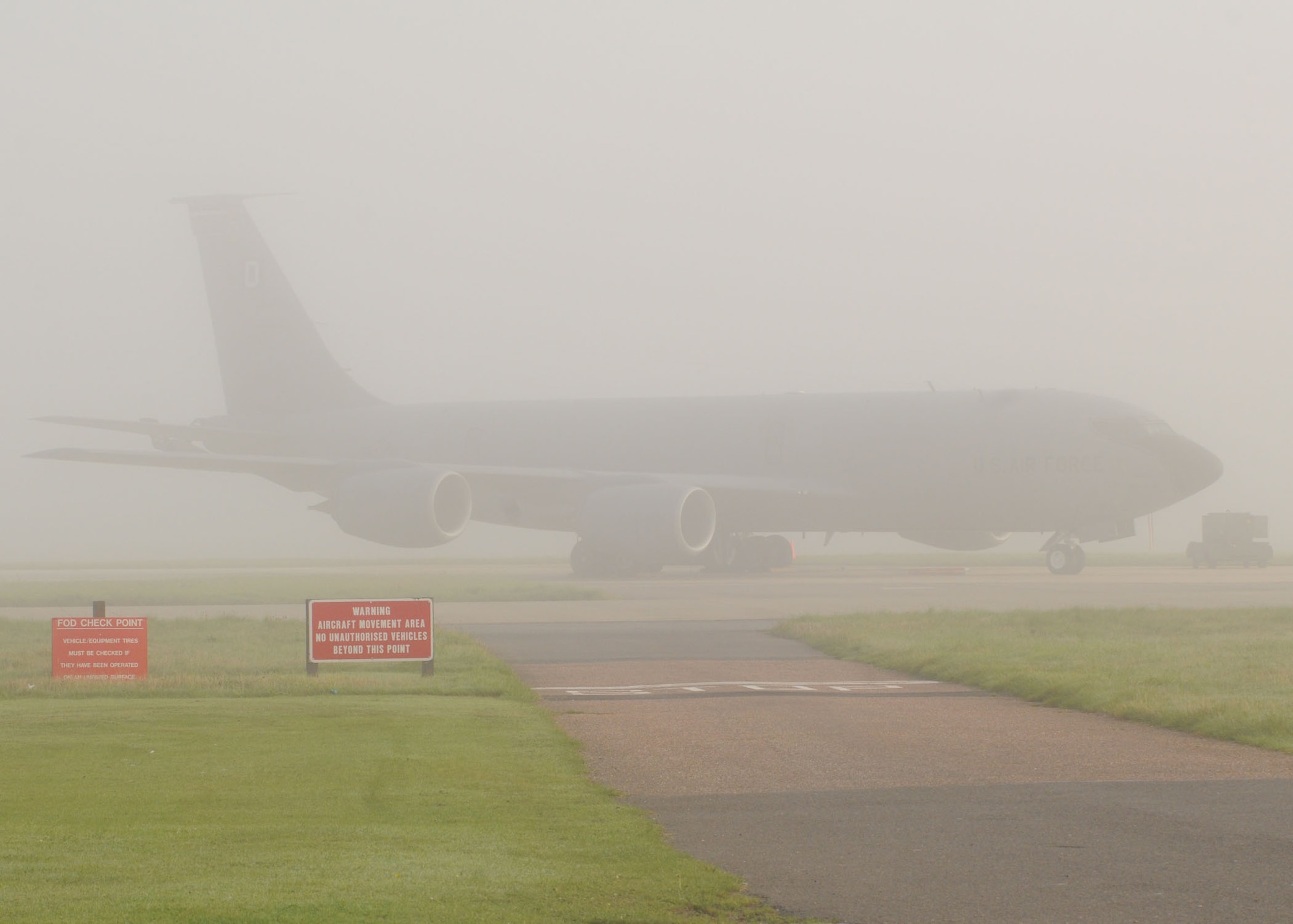 A KC-135 takes cover under a thick blanket of fog during the early morning at RAF Mildenhall, England Sept. 26, 2008. Dense fog can make for zero visibility. Base Safety Office personnel  caution everyone to take more time and to be alert during morning activities. (U.S. Air Force by Staff Sgt. Jerry Fleshman)
