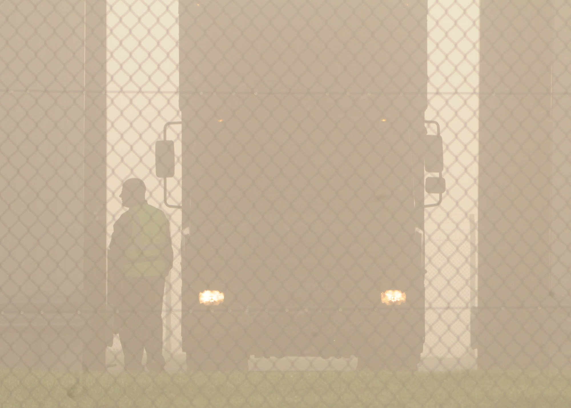 Ministry of Defence employee Tim Dickinson, Access Controller, checks all unauthorized vehicles prior to base entry during heavy fog Sept 26, 2008, at RAF Mildenhall, England. Mr. Dickinson inspects the entire vehicle to ensure no firearms or explosives are present. (U.S. Air Force photo by Staff Sgt. Jerry Fleshman)