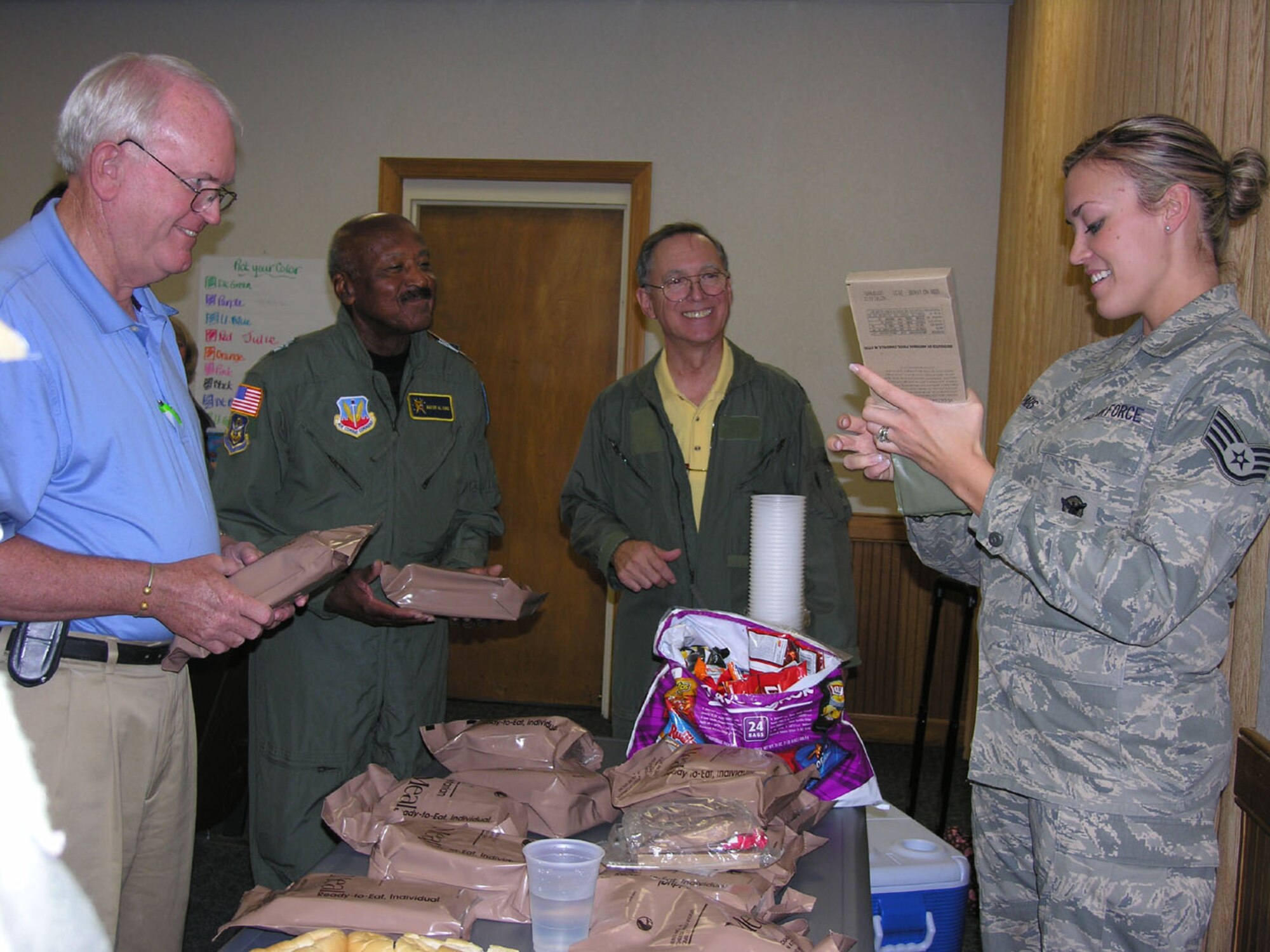 SEYMOUR JOHNSON AIR FORCE BASE, N.C. -- Staff Sgt. Brittany Paus (right), a Reservist with the 916th Security Forces, passes out Meals-Ready-to-Eat to members of the Wayne County Chamber of Commerce during a special 'recruiting' day with the 916th Air Refueling Wing. Chamber members were selected to be 'generals' and were responsible for finding other members they could recruit into the chamber. Chamber members learned about the Air Force Reserve and were able to take a tour of a KC-135 Stratotanker.