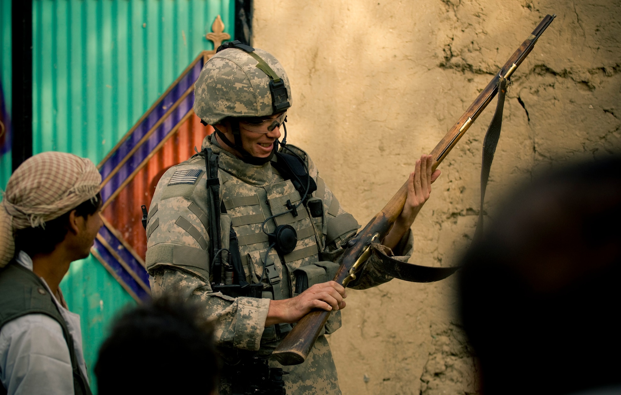 A villager shows an Airman his hunting rifle recently at a village in Afghanistan. Allowing an American to admire his rifle -- his primary means for hunting -- shows the trust local Afghans have for their coalition benefactors. (U.S. Air Force photo/Staff Sgt. Samuel Morse) 

