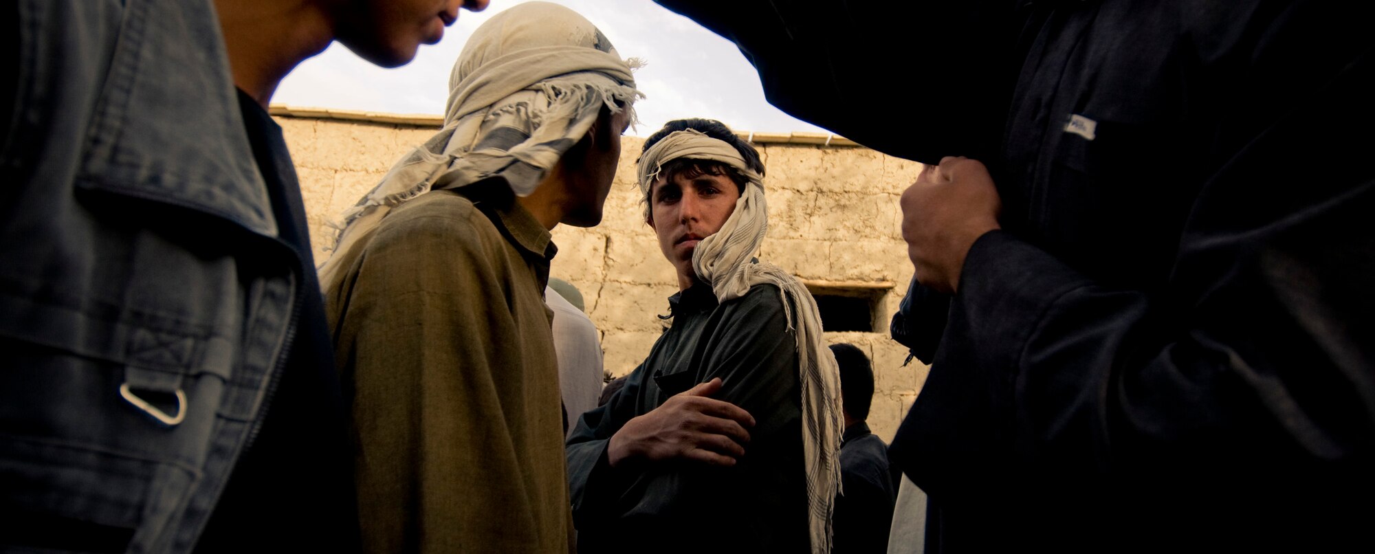 An Afghan villager looks down at a camera recently in an Afghan village. The adults of the village are not as trusting as the children, but appreciated the help from Americans. (U.S. Air Force photo/Staff Sgt. Samuel Morse) 
