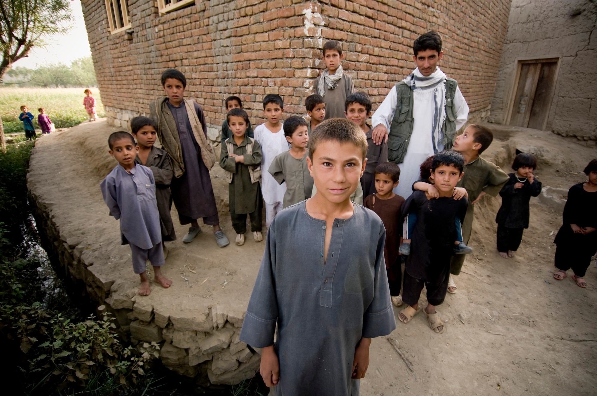 Many Afghan children in a village come out of their homes to see coalition forces visit their village Sept. 16. The villagers were happy to see them and welcomed photos. (U.S. Air Force photo/Staff Sgt. Samuel Morse) 

