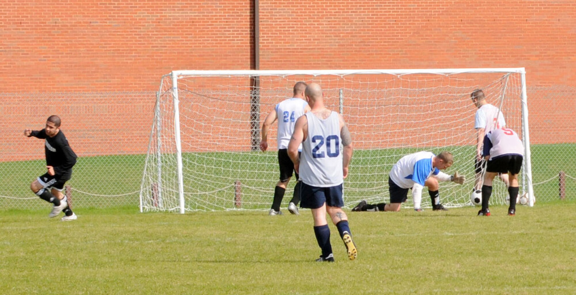 Greg Posada (in black) turns away in triumph after scoring the winning goal for the 100th FSS to defeat the 95th RS 3-2 during the outdoor soccer championship at the Hardstand Sports field, Sept. 26. (U. S. Air Force photo by Staff Sgt. Jerry Fleshman)