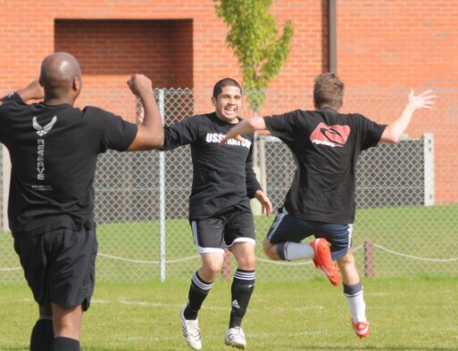 Jumping for joy, the 100th FSS players celebrate after winning the game with seconds to spare in extra time. The 100th FSS defeated the 95th RS 3-2 to win the outdoor soccer championship, Sept. 26. (U.S. Air Force photo by Staff Sgt. Jerry Fleshman)