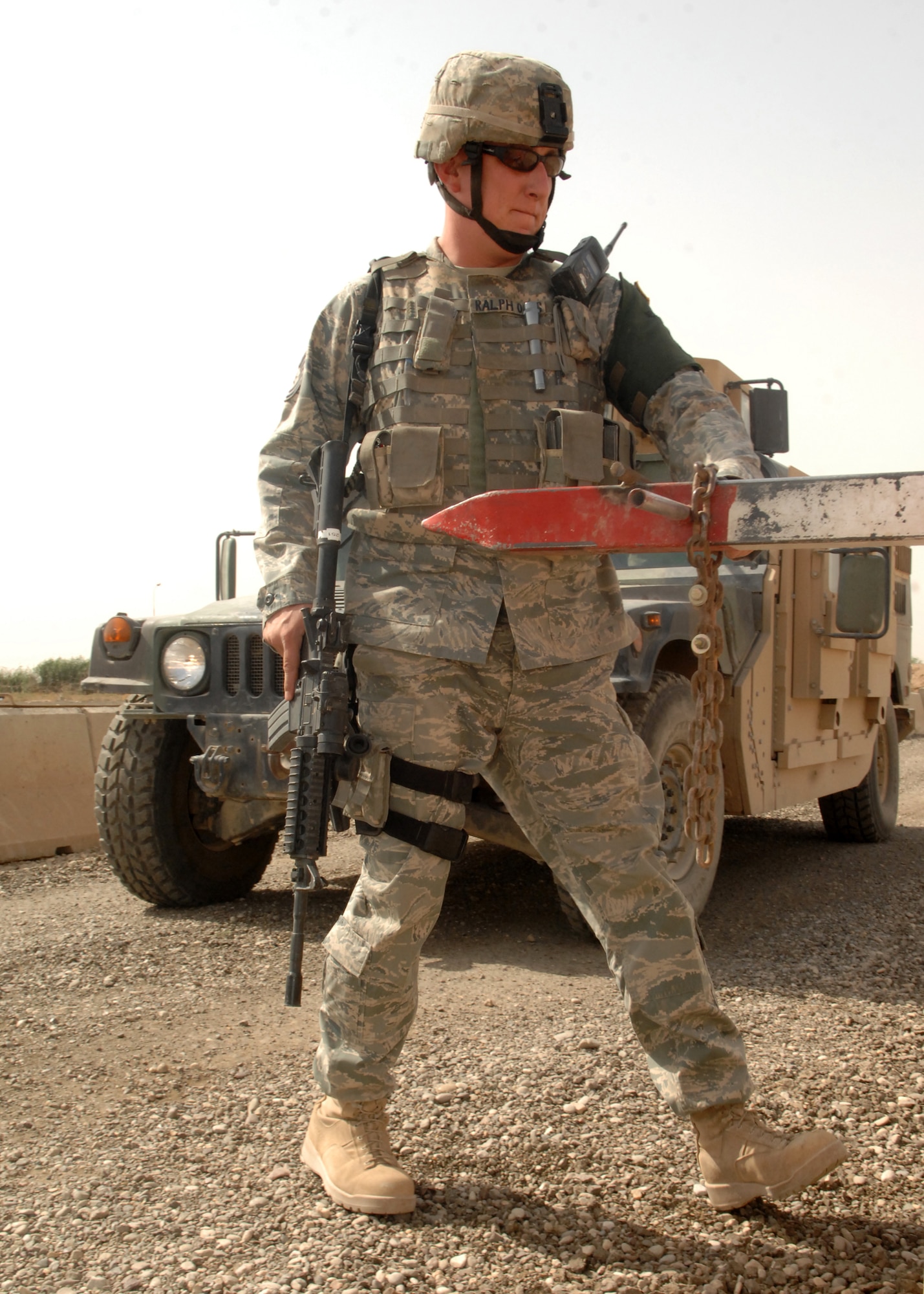 KIRKUK REGIONAL AIR BASE, Iraq -- Tech. Sgt. Chad Ralph, 506th Expeditionary Security Forces Squadron flight supply and response force leader, opens a gate for a Humvee here Sept 27.  Sergeant Ralph is one of many security forces Airmen deployed to ensure base defense.The 506th ESFS, the largest squadron on Kirkuk, comprises almost half of the 506th Air Expeditionary Group and includes both active-duty and reserve Airmen from 32 different home-station units. Sergeant Ralph is deployed from Luke Air Force Base, Ariz. and calls Queen Creek, Ariz., home. (U.S. Air force photo/Senior Airman Randi Flaugh)
