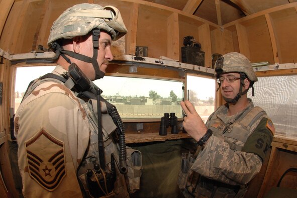 KIRKUK REGIONAL AIR BASE, Iraq -- Tech. Sgt. Michael Yavello, 506th Expeditionary Security Forces Squadron response force leader, reads a post brief to Master Sgt. John Newman, 506th ESFS assistant flight chief, here Sept 27.  Sergeants Newman and Yavello are one of many security forces Airmen deployed to ensure base defense.  The 506th ESFS, the largest squadron on Kirkuk, comprises almost half of the 506th Air Expeditionary Group and includes both active-duty and reserve Airmen from 32 different home-station units.  Both sergeants are deployed from Luke Air Force Base, Ariz.  Sergeant Newman calls Abondale, Ariz., home and Sergeant Yavello calls Scottsdale, Ariz., home.(U.S. Air Force photo/Senior Airman Randi Flaugh) 