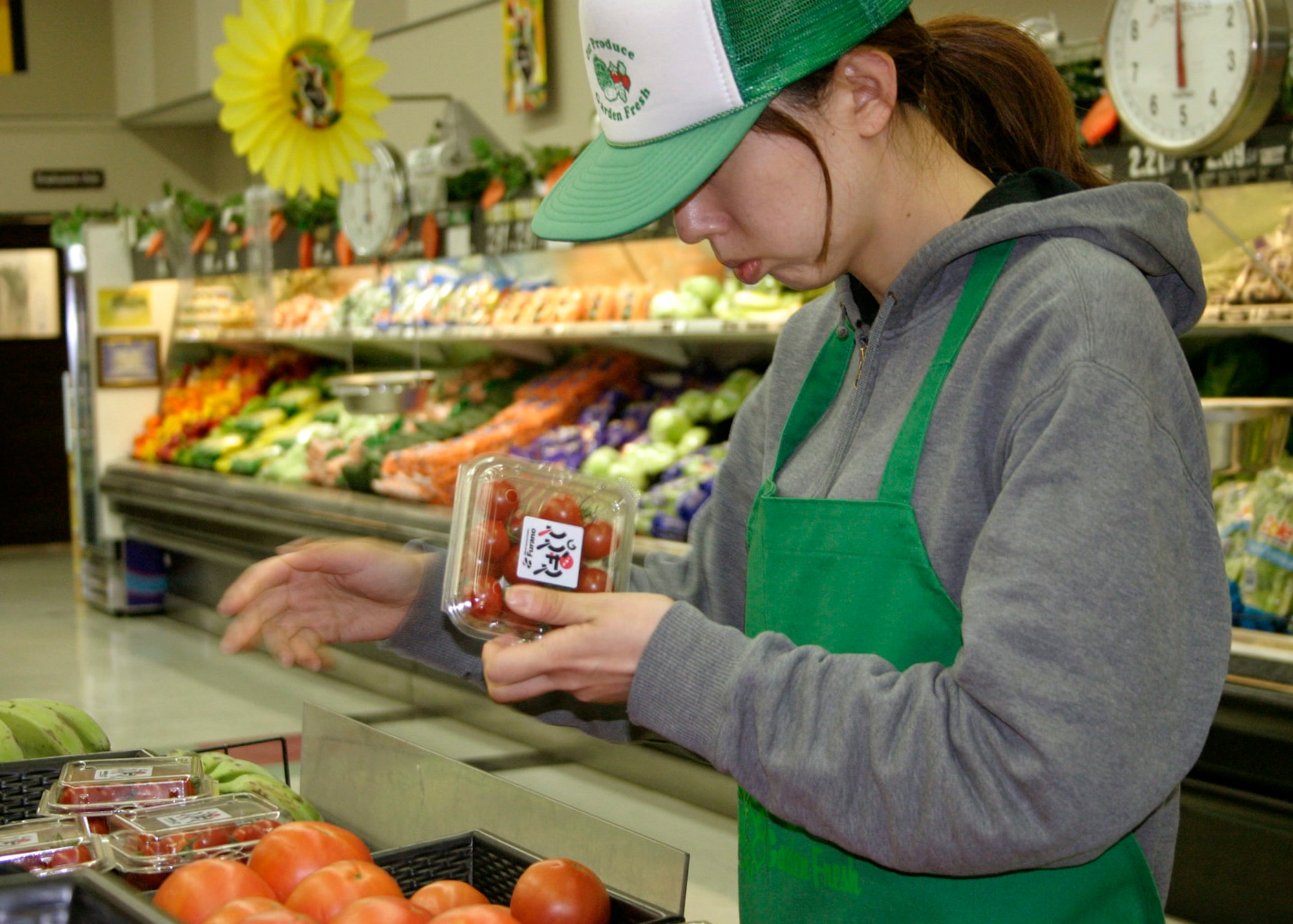 MISAWA AIR BASE, Japan -- Toshiko Ebina, commissary produce department manager, checks the quality of all packaged produce before placing it out for consumers to purchase Sept. 4, 2008. (U.S. Air Force photo by Staff Sgt. Araceli Alarcon)