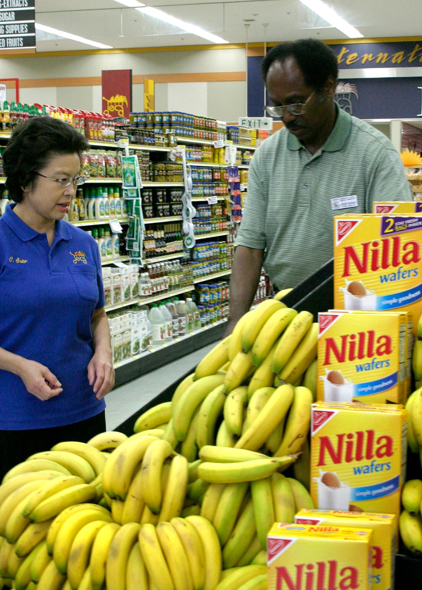 MISAWA AIR BASE, Japan -- Suto Chiyuki, commissary produce department superintendent, and Greg McGruder, commissary manager, check displays at the commissary designed to catch shopper's eyes as they walk in Sept. 4, 2008. Mr. McGruder and his team are finding new ways of improving the quality and price of the produce sold at the commissary. (U.S. Air Force photo by Staff Sgt. Araceli Alarcon)