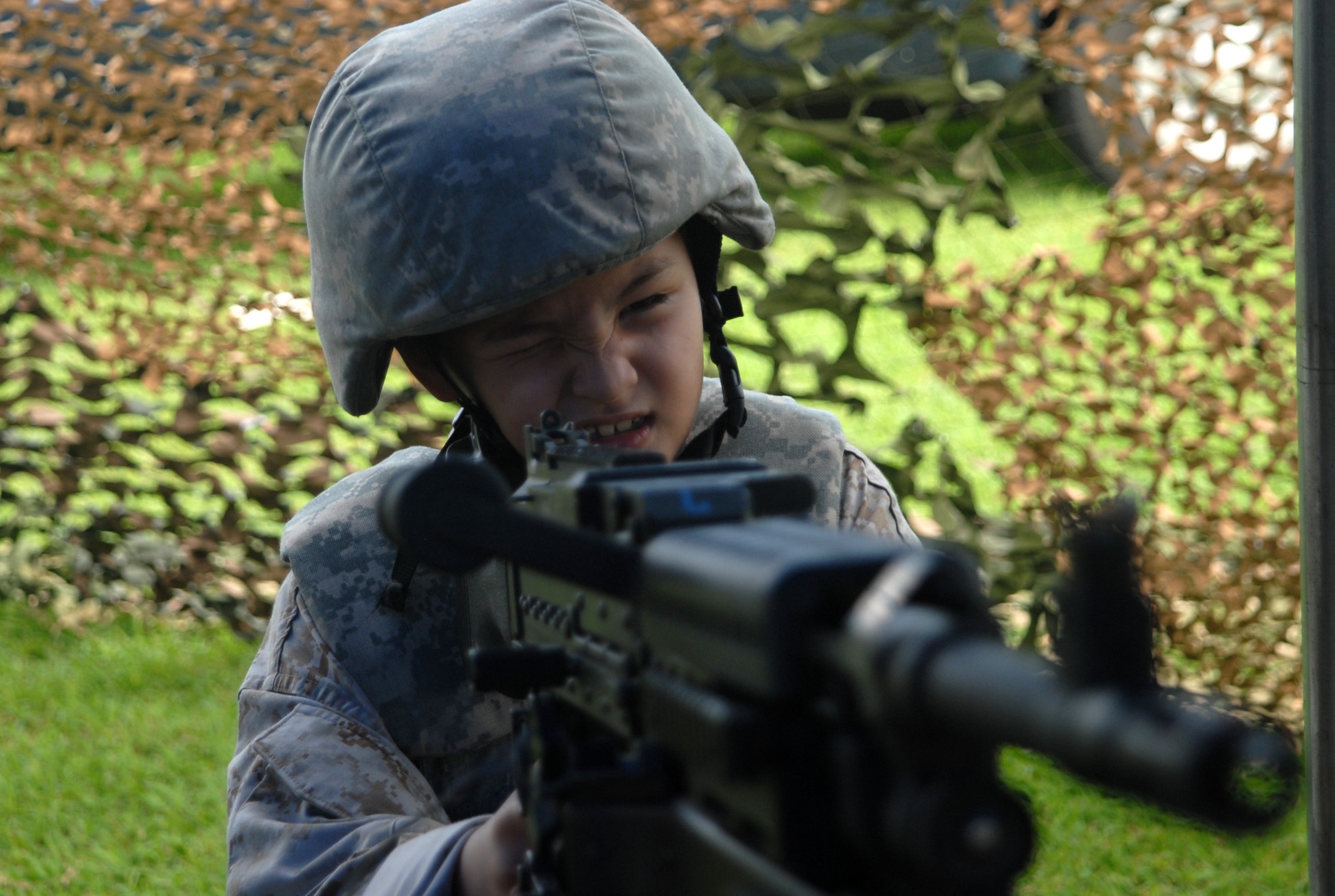 William Rudolph, 7, son of Marine Gunnery Sgt. Robert Rudolph, Marine Corps Station Futenma, takes aim inside the 18th Security Forces tent Sept. 27 during this year's Skoshi Warrior event at Marek Park. The Airman and Family Readiness Center-sponsored event was designed to show children of deploying or deployed servicemembers what their parents experience before and during a deployment. (U.S. Air Force official photo/Staff Sgt. Nestor Cruz)