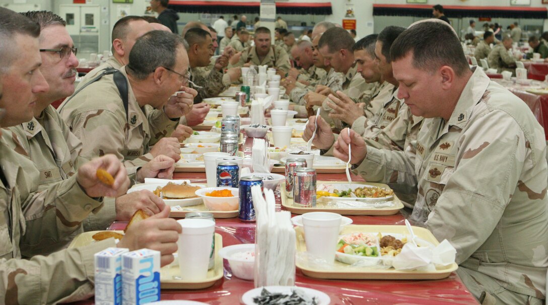 A group of Navy Chiefs enjoy lunch together during the 116th birthday celebration for the rank of Chief Petty Officer.  Although the Chiefs are currently in Iraq, they still made time to honor an important milestone.  (U.S. Marine Corps photo by Cpl Alan Addison)