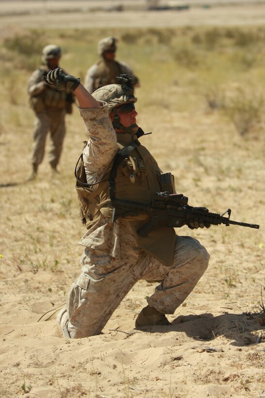 Lance Cpl. Justin Jarvis, a light armored vehicle crewman with Company E, 3rd Light Armored Reconnaissance Battalion, throws a dummy grenade during a dry run of the company’s training exercise April 1. The remain behind element of 3rd LAR conducted cross training to educate its Marines every aspect of their jobs.