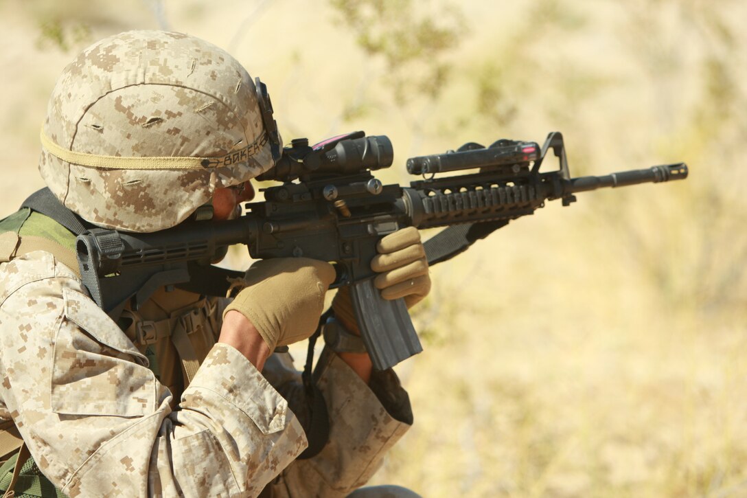 Shell casings fly as Lance Cpl. Sterling Baker, a light armored vehicle crewman with Company E, 3rd Light Armored Reconnaissance Battalion, provides cover fire for another Marine during their buddy rush training.