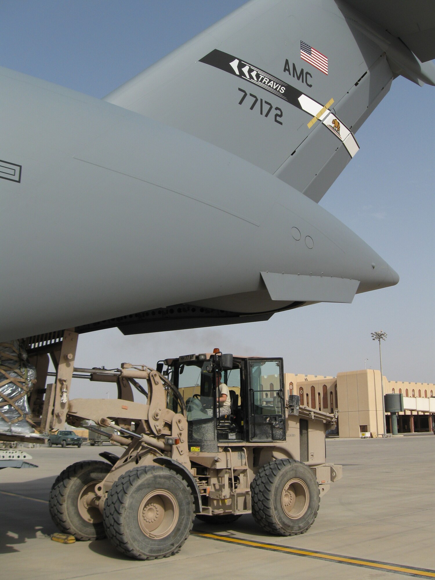 Airman 1st Class Daniel Cuhen, 615th Contingency Response Wing-Contingency Response Element, unloads cargo from a C-17 Globemaster III from Travis Air Force Base, Calif., at Basra International Airport, Iraq.  Airman Cuhen is deployed to Basra as part of a Contingency Response Element that is supporting the transition of responsibility from British Forces to the U.S. (U.S. Air Force photo/Lt. Col. John Howard)