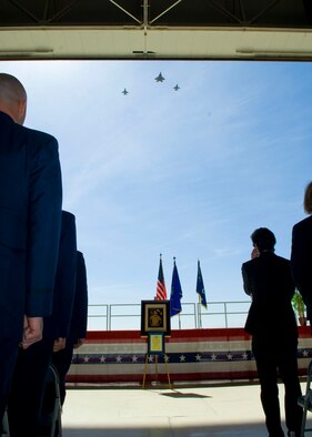 A missing-man formation flies over Hangar 1600 during a memorial service for retired Lt. Col. David Cooley April 1. Colonel Cooley, Lockheed Martin F-22A Raptor test pilot, died in an F-22A crash March 25 during a test mission, northeast of Edwards. (U.S. Air Force photo/Mike Yncera)
