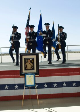 The Edwards Blue Eagles Honor Guard marches at the podium during a memorial service for retired Lt. Col. David Cooley at Hangar 1600 April 1. Colonel Cooley, Lockheed Martin F-22A Raptor test pilot, died in an F-22A crash March 25 during a test mission, northeast of Edwards. (U.S. Air Force photo/Mike Yncera)