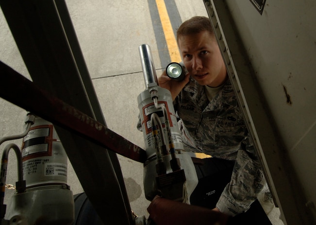 Tech. Sgt. Robert Pellam carefully inspects landing gear hydraulics on a C-17 as part of a quality assurance inspection here April 1. Sergeant Pellam is a fabrication quality inspector with the 437th Maintenance Group. (U.S. Air Force photo/Senior Airman Timothy Taylor)
