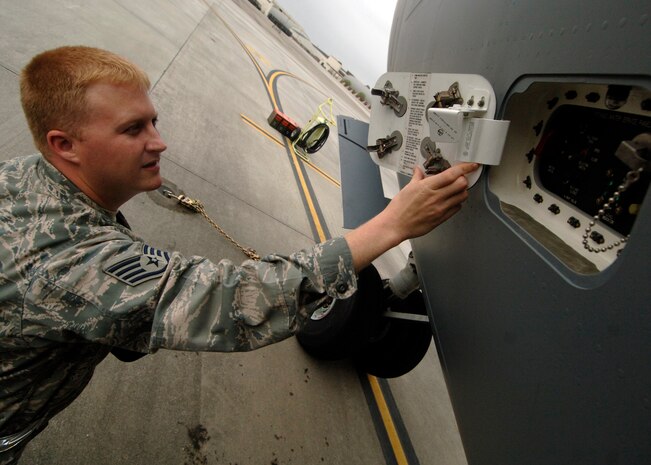 Staff Sgt. Andrew Alford inspects an access cover for the potable water for security and to ensure the hinge pins are installed correctly on a C-17 here April 1. Quality assurance checks are performed to ensure maintenance quality, personal safety, reliability and flight safety are adhered to for the 437th Maintenance Group. Sergeant Alford is a crew chief quality assurance inspector for the 437th Maintenance Group. (U.S. Air Force photo/Senior Airman Timothy Taylor)